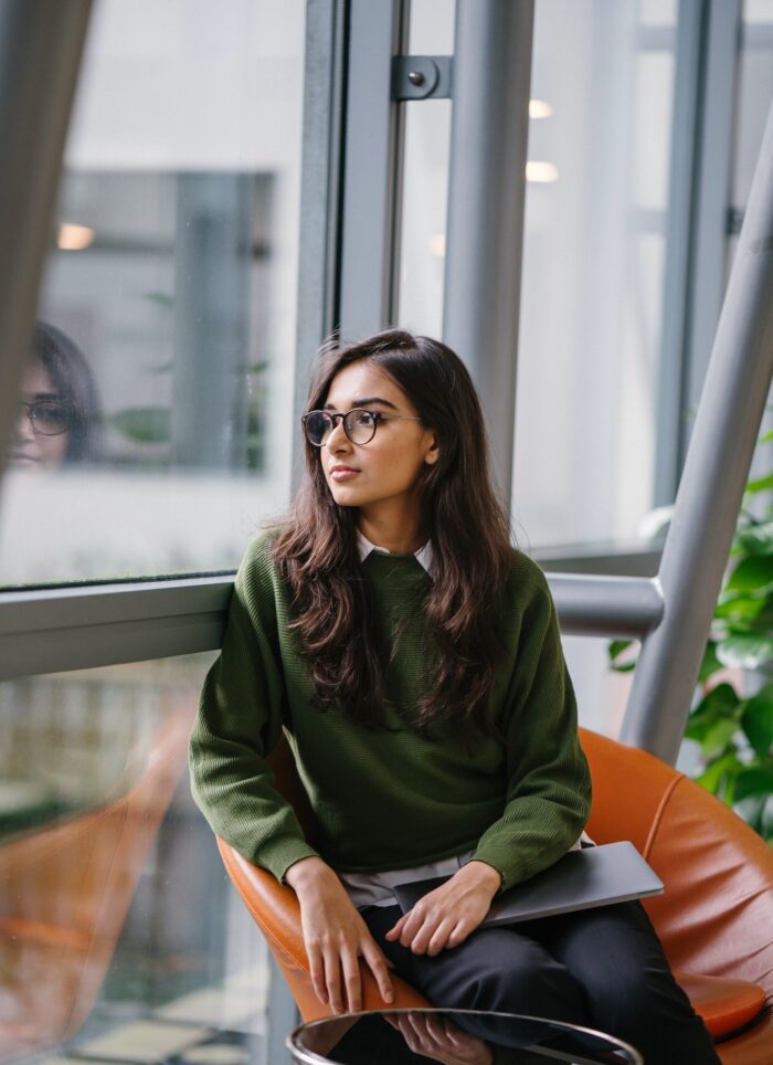 young contemplative woman looking out a window